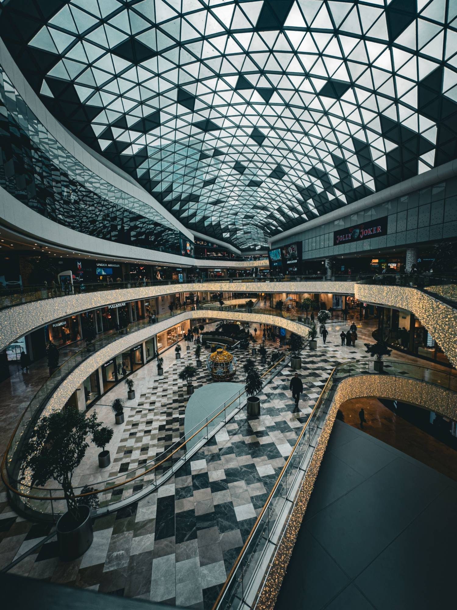 Soaring glass-roofed atrium of a modern development